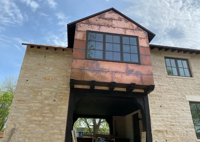 Copper metal panel facade on a stone building for Metal Roof Coating in Green Lake