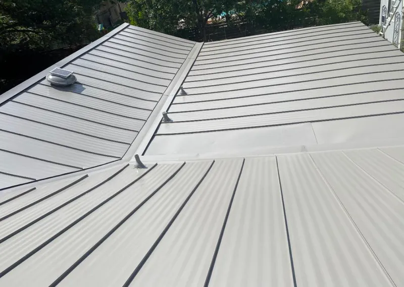 Solar attic fan installed on a metal roof for Roof Ventilation in Green Lake